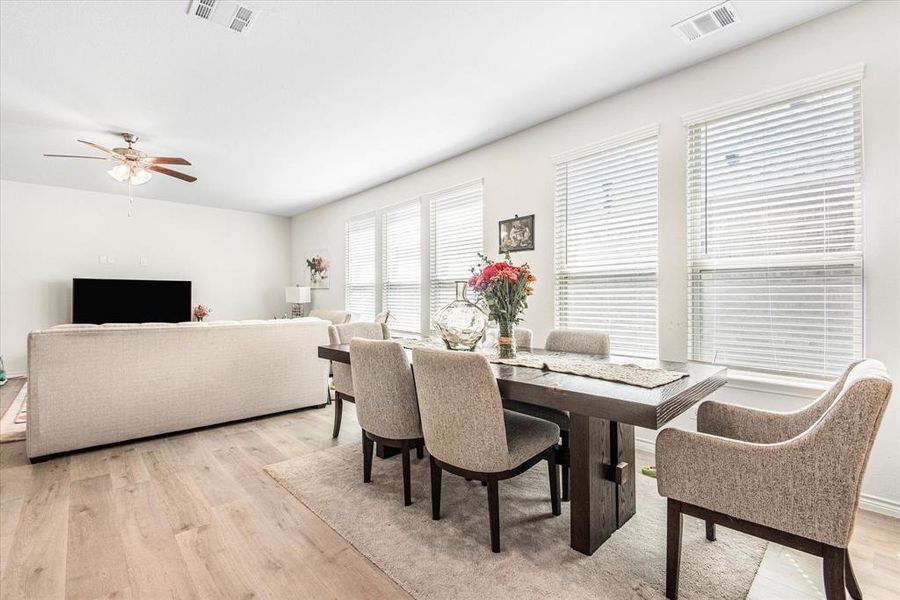 Dining area with light wood-type flooring and ceiling fan