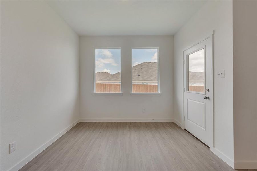 Empty room with light hardwood / wood-style flooring