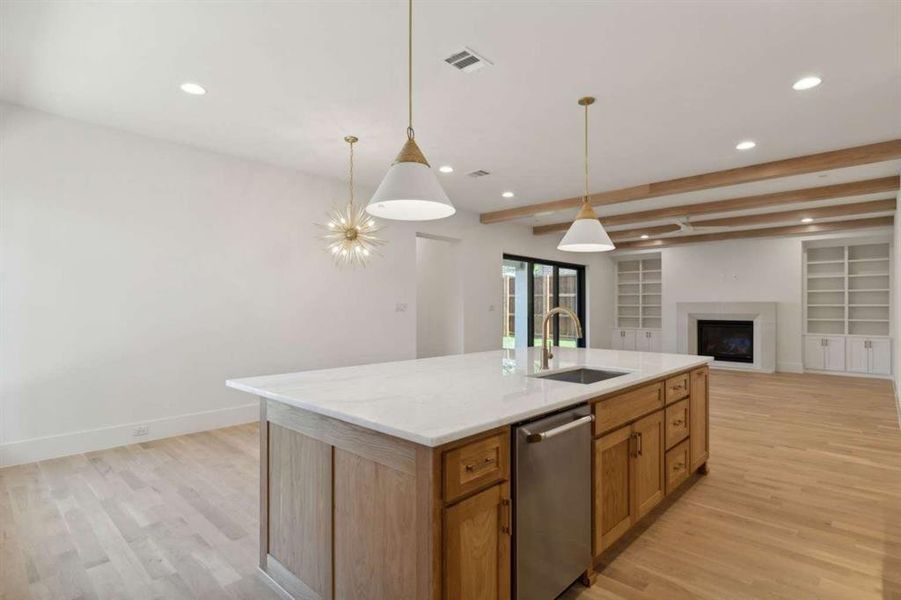 Kitchen with beamed ceiling, sink, light hardwood / wood-style flooring, a center island with sink, and dishwasher