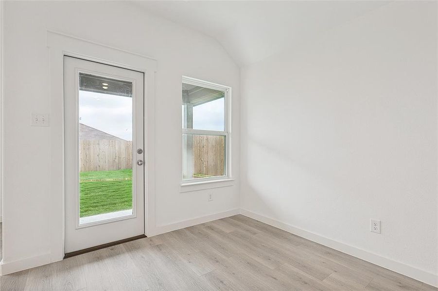 Entryway with light hardwood / wood-style floors and vaulted ceiling