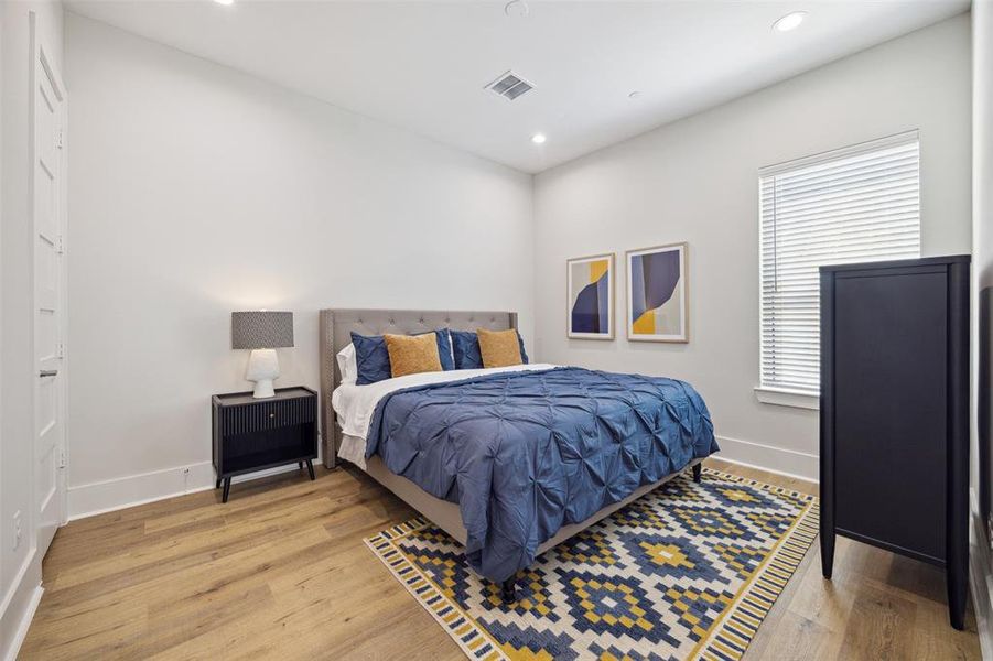 Secondary bedroom on the third level features a large closet and an en-suite bath.