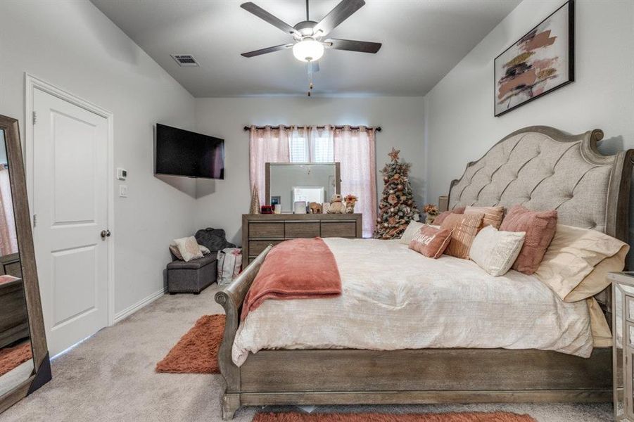 Bedroom with light carpet and ceiling fan