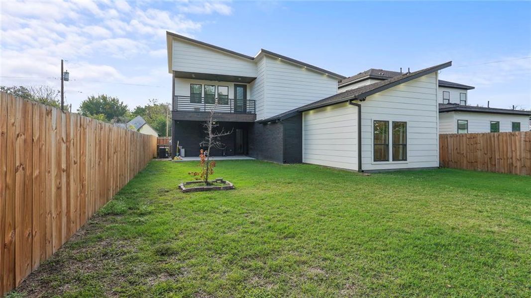 Back of house featuring a lawn