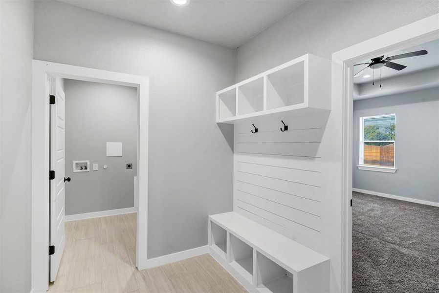 Mudroom featuring light carpet and ceiling fan