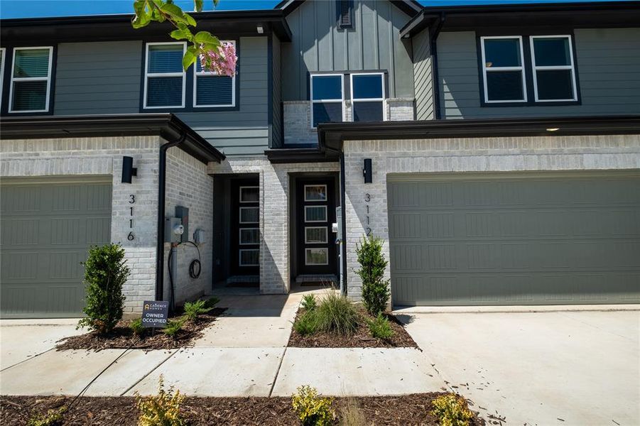 White brick with striking trim colors create ample curb appeal for this fantastic home!