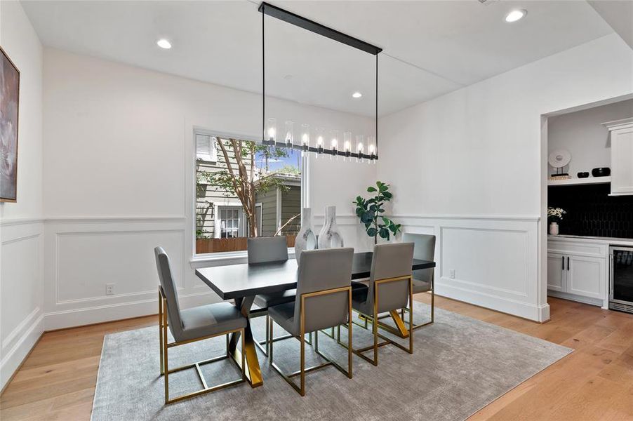 Formal dining adjacent to the wet bar with designer chandelier.