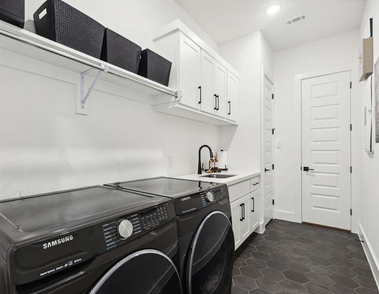 Laundry may be an ongoing chore, but in this home, it will be an easy and fun one! Featuring mounted cabinetry, the spacious laundry room has an area for storing essentials and access to primary closet.