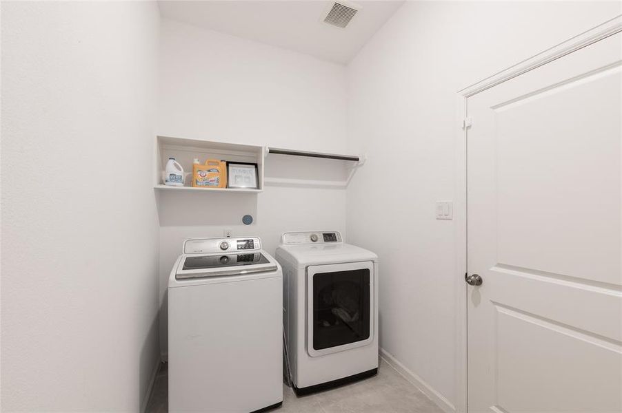 Spacious laundry room with modern appliances, perfect for tackling your daily chores