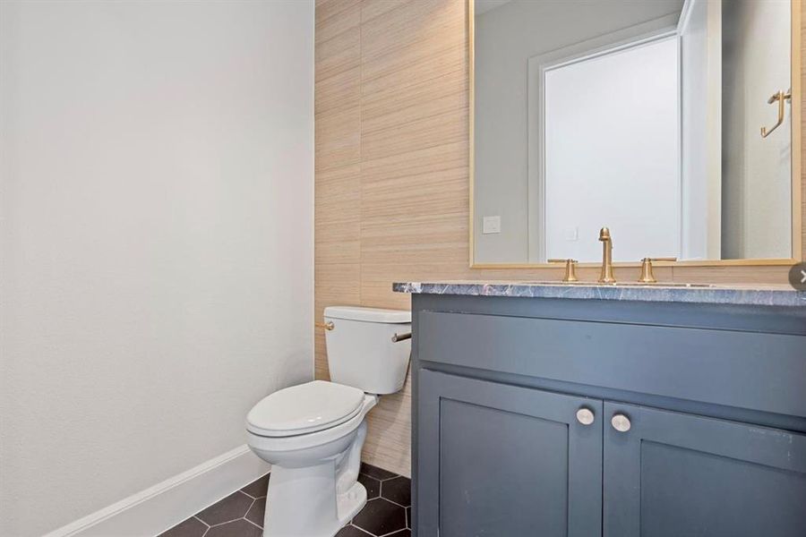 Bathroom featuring tile patterned flooring, toilet, and vanity