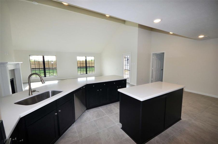 Kitchen is open to the family room and shares a cathedral ceiling.