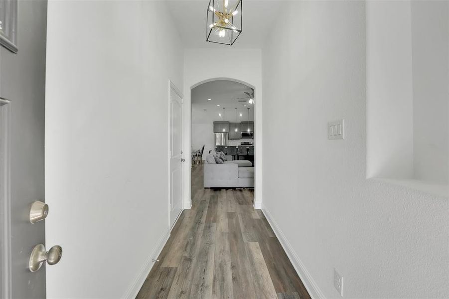 Corridor with hardwood / wood-style flooring