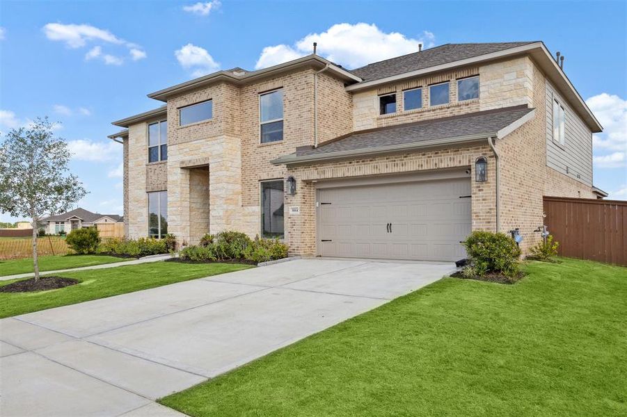 The double wide driveway leads to a 3-car tandem garage.