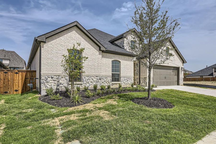 French country style house featuring a front lawn