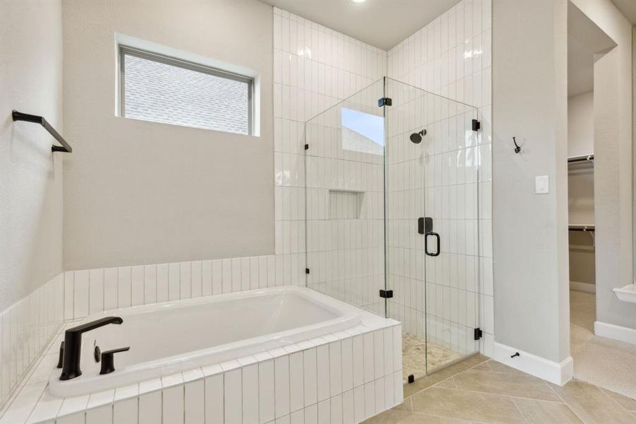 Bathroom featuring independent shower and bath and tile patterned flooring