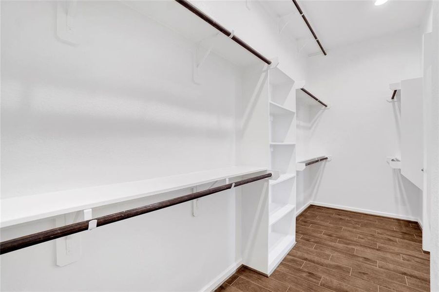 Huge Walk in closet with three levels of hanging space in the primary room