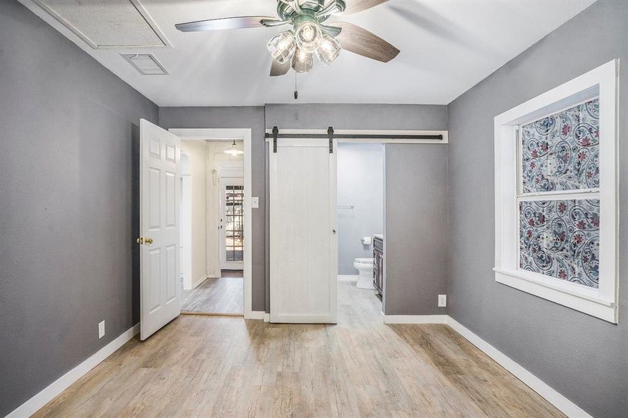 Primary Bedroom with Barn door for bathroom entry and closet.