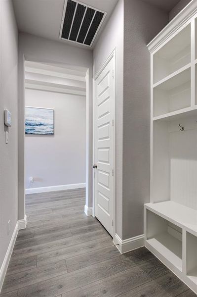 Mudroom with wood-type flooring