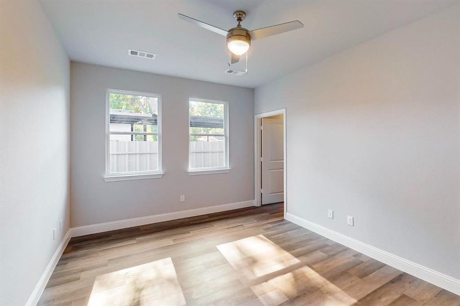 Empty room featuring light wood-type flooring and ceiling fan