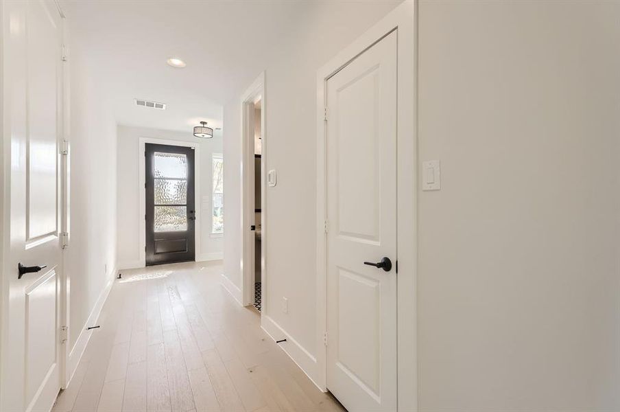 Hallway with light hardwood / wood-style flooring