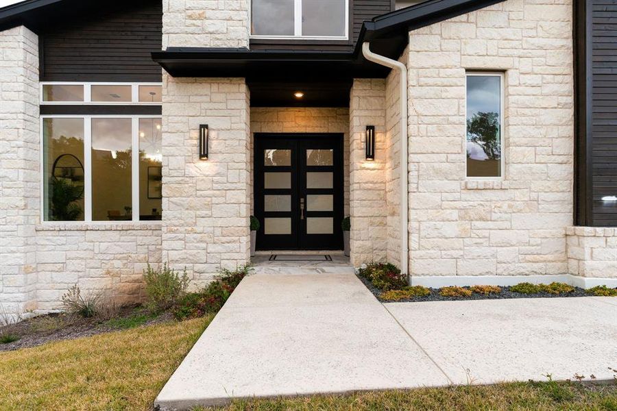 upon entering you are greeted by oversized custom metal doors