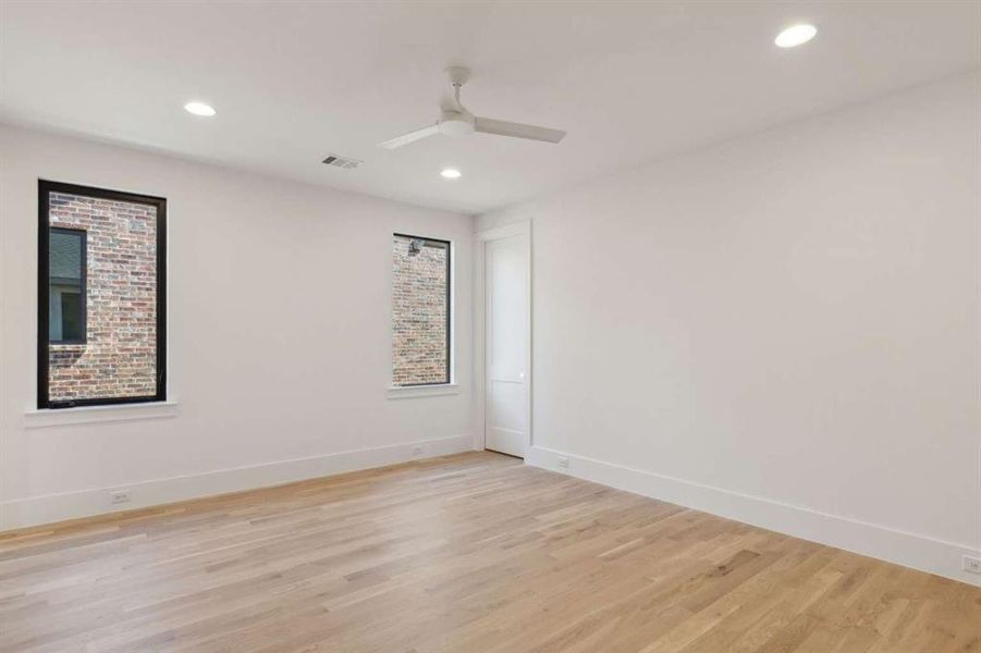 Empty room featuring ceiling fan and light wood-type flooring