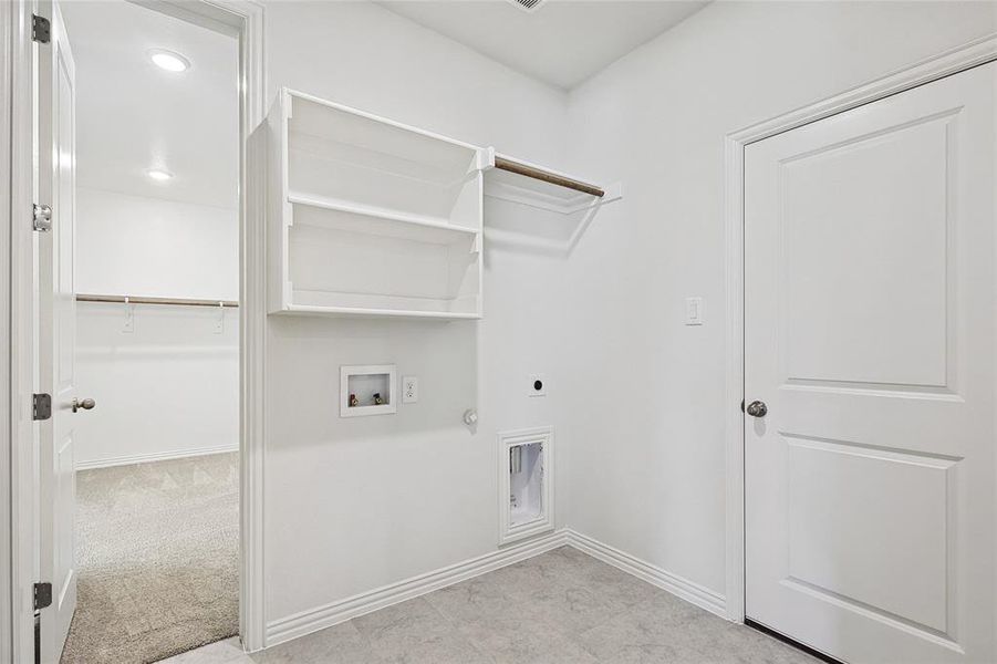 Washroom featuring gas dryer hookup, light carpet, hookup for an electric dryer, and washer hookup