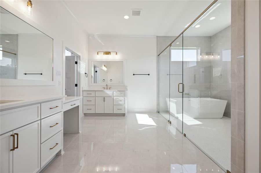 Bathroom with vanity, a healthy amount of sunlight, and shower with separate bathtub