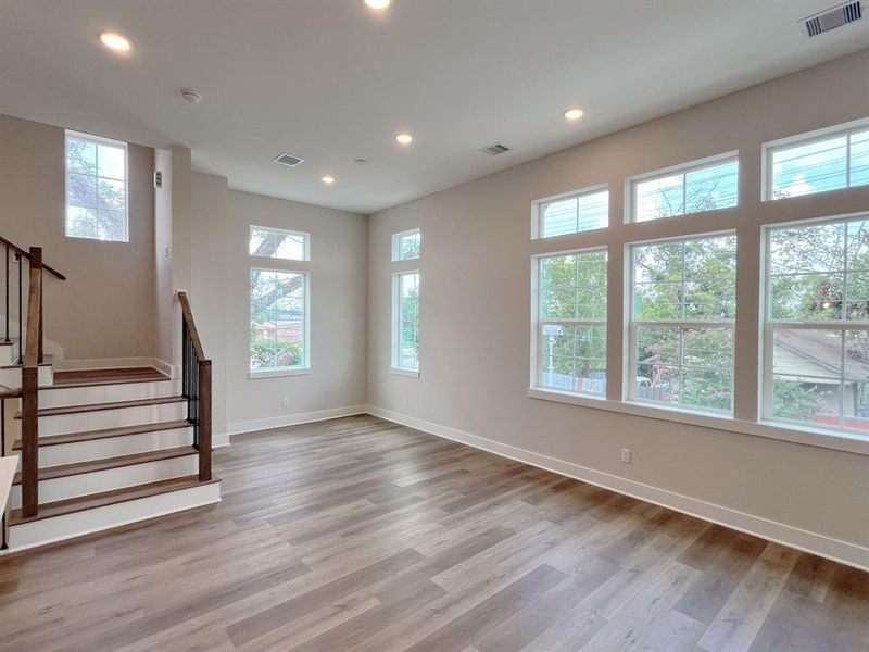 Spacious Open-Concept Living/Dining Area with Abundant Natural Light and Modern Finishes