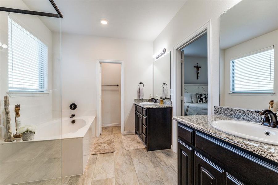 Bathroom with vanity and a bath