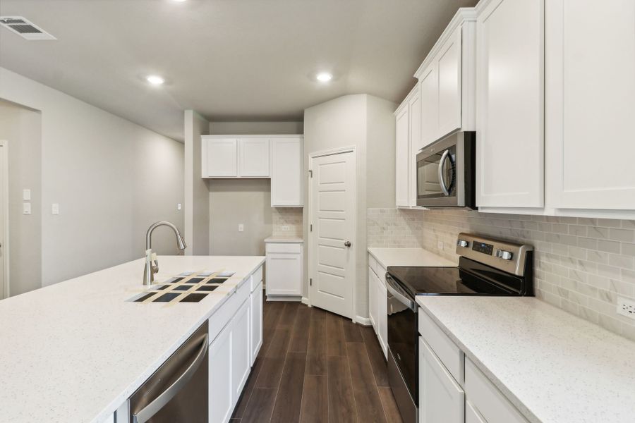 Kitchen in the Hughes floorplan at a Meritage Homes community.