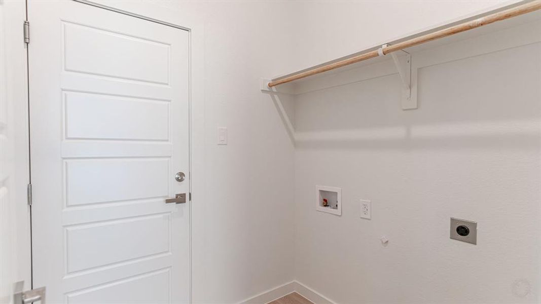 Utility room with washer/dryer hookups and hanging rod