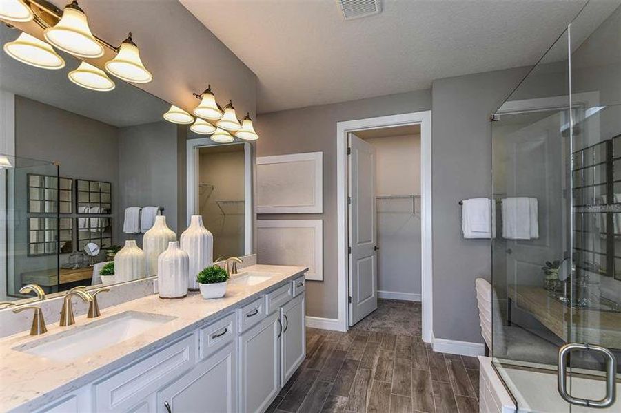Owner's En Suite Bathroom and Walk-In Closet. Model home design. Pictures are for illustration purposes only. Elevations, colors and options may vary. Furniture is for model home only.