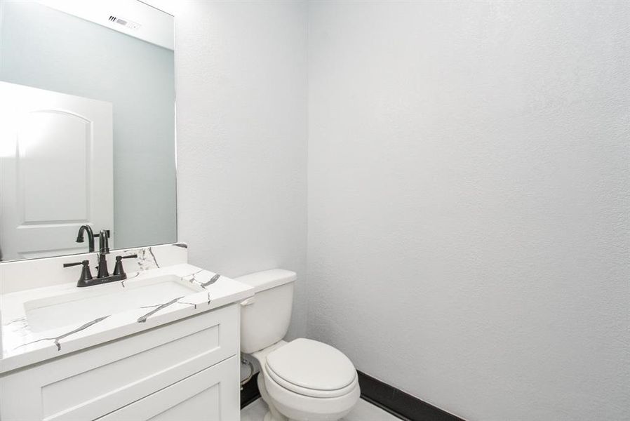 By the entrance, conveniently located, you'll find a half bath, perfect for visitors.