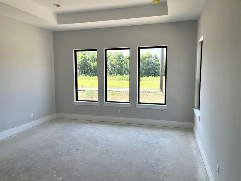 Primary bedroom with coffered ceiling.