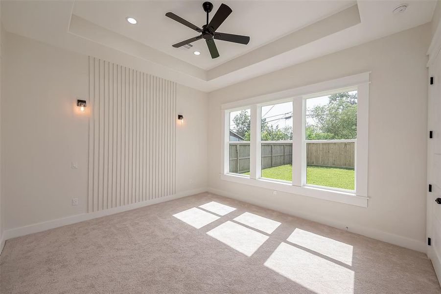 Your primary bedroom features a statement wall with lights on both sides of what would be your bed