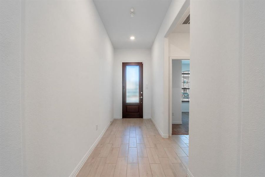 Doorway to outside with light hardwood / wood-style flooring