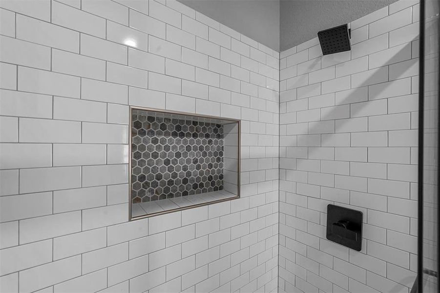 Interior details featuring a tile shower