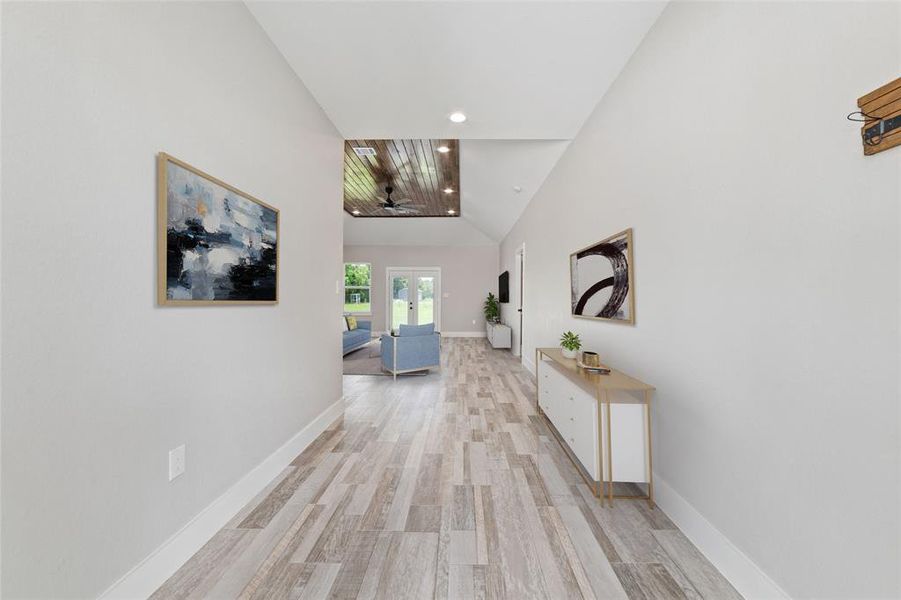 Virtually Staged. As you step through the welcoming entryway, your attention is immediately drawn to the sleek tile flooring that spans the expansive hallway. This wide walkway not only enhances the sense of space but also effortlessly guides you into the inviting open living room ahead.