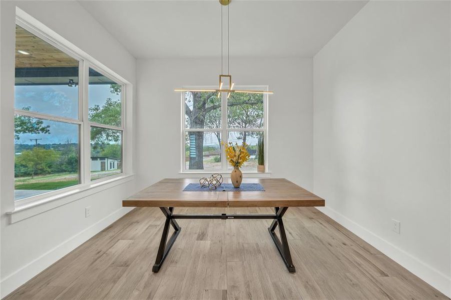 Dining room featuring light wood-type flooring and plenty of natural light