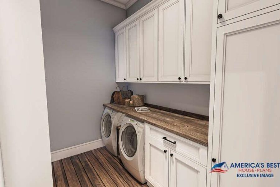 Laundry room with dark wood-type flooring, washing machine and dryer, and cabinets