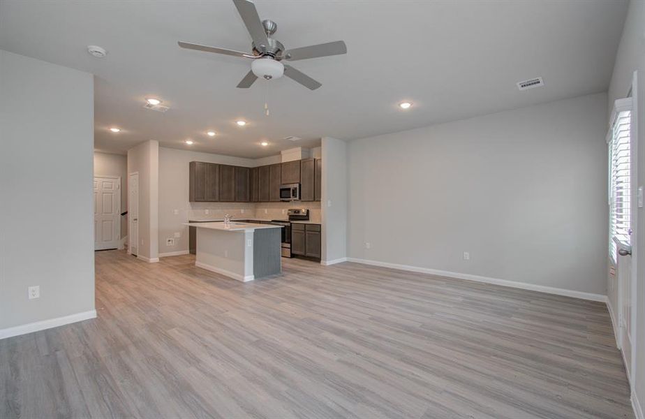 Open concept kitchen/dining living area located on first floor