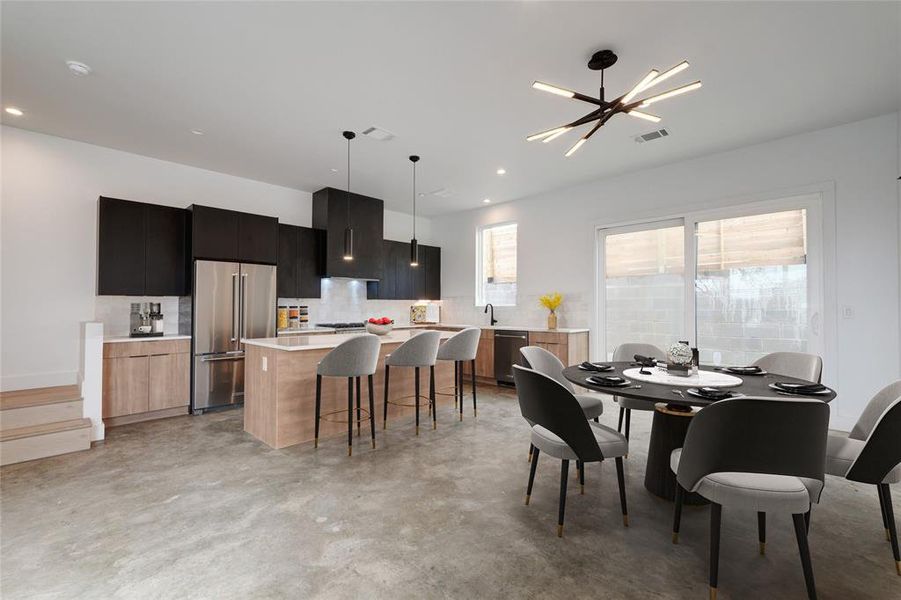 Open concept eat-in kitchen and dining room. Virtually staged photo