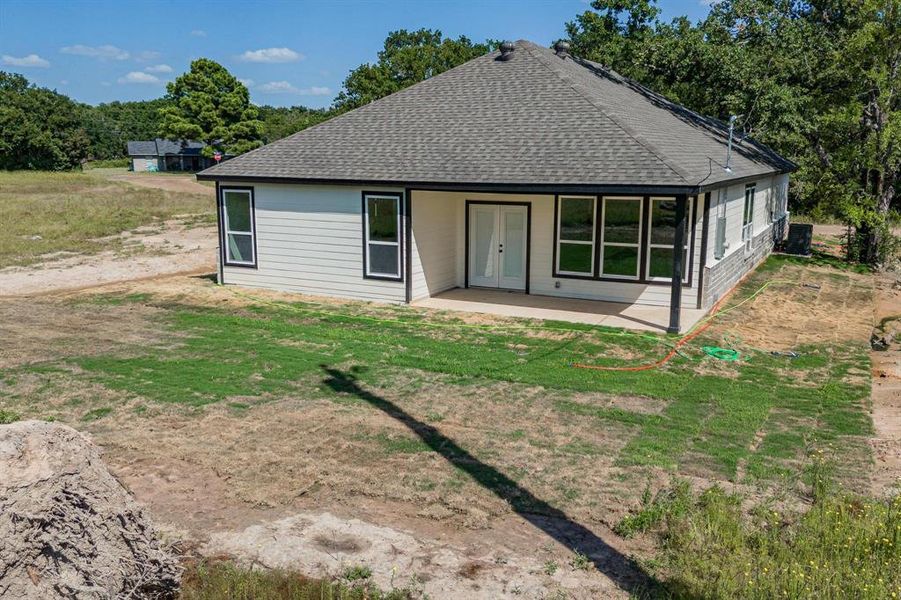 Staged Rear view of house featuring a patio and a yard