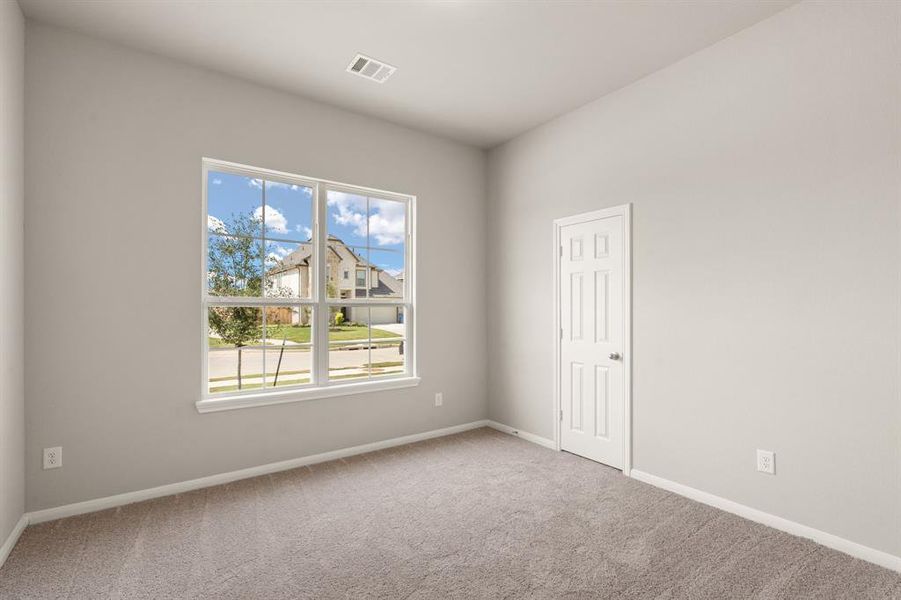 Your secondary bedroom features plush carpet, fresh paint, closet, and a large window that lets in plenty of natural lighting.