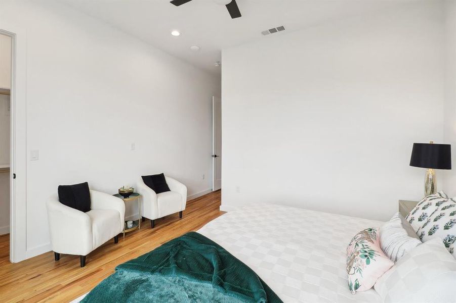 Bedroom with light hardwood / wood-style flooring and ceiling fan