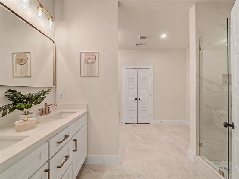 Bathroom with a shower with door and vanity