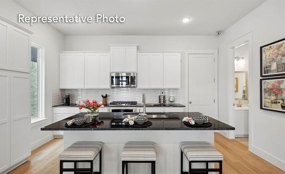 Kitchen featuring light wood-type flooring, appliances with stainless steel finishes, and a kitchen island