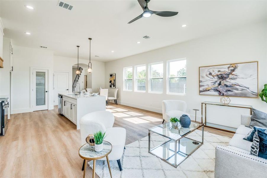 Living room with ceiling fan, sink, and light hardwood / wood-style floors