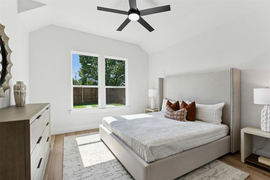 Bedroom featuring lofted ceiling, light wood-type flooring, and ceiling fan