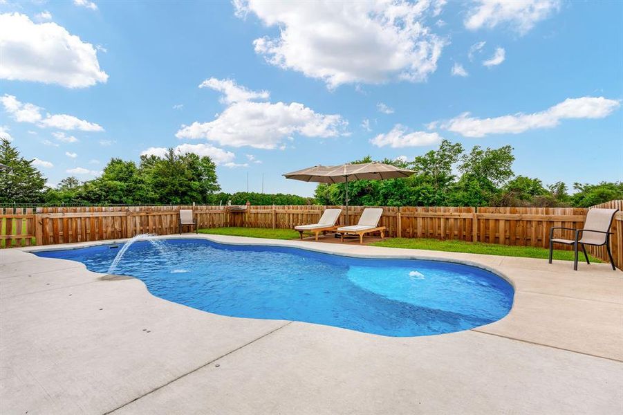 Fiberglass pool featuring a large patio area perfect for hot summer afternoons.